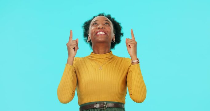 Face, happy black woman and pointing up in studio isolated on a blue background mockup space. Portrait, funny and African person with hand for advertising, marketing or commercial promotion for brand