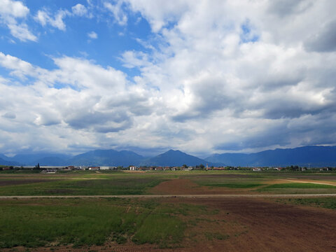 fields and mountains in the background with very cloudy sky in the Po Valley in northern Italy in winter without people