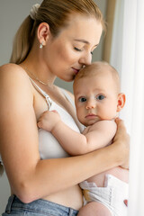 Single parent being playful and affectionate, embracing precious moments with her new born child