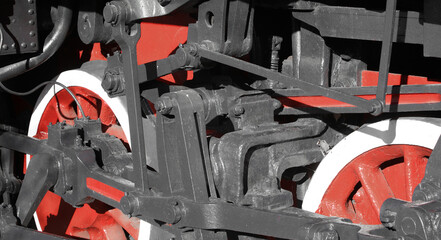 detail of red and white metallic wheels of the old black one.train steam locomotive