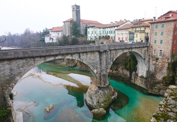 Fototapeta na wymiar OLD bridge called PONTE DEL DIAVOLO which means devil s bridge in Italian of the town of CIVIDALE in the province of UDINE in Italy and the Natisone river