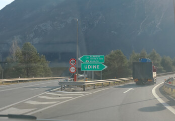 crossroads of a motorway in northern Italy with signs for the city of TARVISIO or UDINE