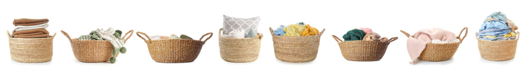Set of wicker baskets with laundry isolated on white