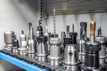 Tools for working on a CNC machine are arranged in racks for quick search and selection.