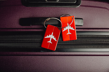 Close up of luggage tag label on suitcase or bag with travel insurance. 