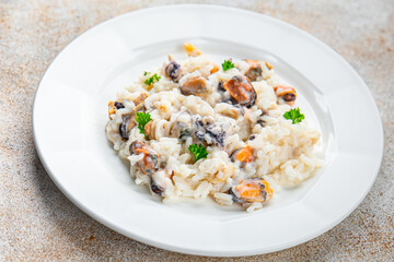 risotto seafood mussel, squid, shrimp fresh rice cooking meal food snack on the table copy space food background rustic top view Pescetarian diet