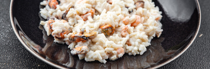 risotto seafood mussel, squid, shrimp fresh rice cooking meal food snack on the table copy space food background rustic top view Pescetarian diet