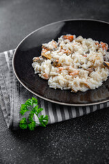 risotto seafood mussel, squid, shrimp fresh rice cooking meal food snack on the table copy space food background rustic top view Pescetarian diet
