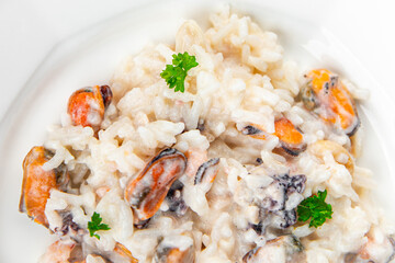 risotto seafood mussel, squid, shrimp fresh rice cooking meal food snack on the table copy space food background rustic top view Pescetarian diet