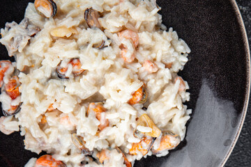 risotto seafood mussel, squid, shrimp fresh rice cooking meal food snack on the table copy space food background rustic top view Pescetarian diet