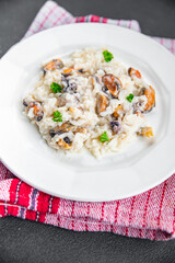 risotto seafood mussel, squid, shrimp fresh rice cooking meal food snack on the table copy space food background rustic top view Pescetarian diet