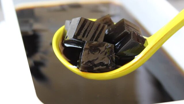 Blurry footage of traditional jelly made from plant Platostoma palustre as beverage. Called as cincau hitam or janggelan in Indonesia