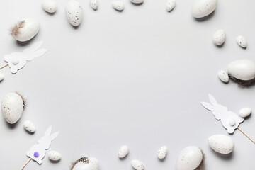 Frame made of Easter eggs and decor on light background, closeup