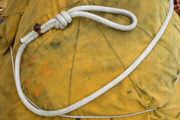 Close-up of a rope with a knot for quick attachment on the port of Grado, Italy. Items for fishing...