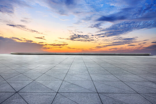 Empty brick floor and sunset clouds background