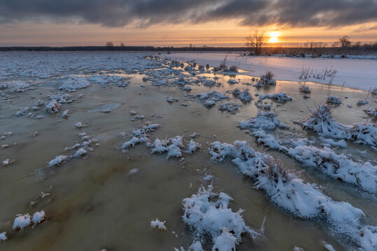 sunset on floodplains in estonia - winter in northern europe