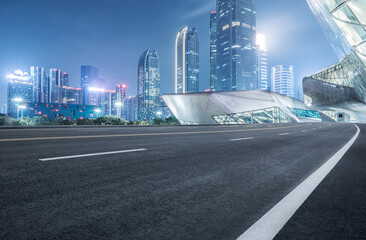 Empty asphalt road and city buildings landscape at night in Guangzhou - obrazy, fototapety, plakaty