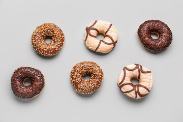 Sweet chocolate donuts on grey background