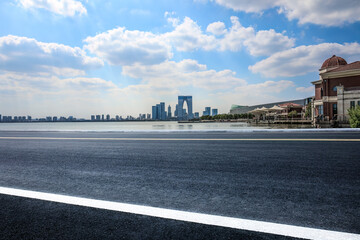 City empty asphalt road and buildings skyline in summer
