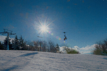 Ski lift with large sunburst on winter day paintography