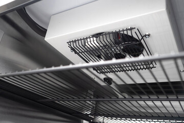 Refrigeration equipment from inside. Fan in freezer. Fragment refrigerator with mesh shelves....