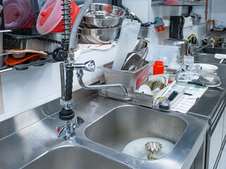 Restaurant sinks with dirty dishes. Place washing utensils in cafe. Dishwasher workplace....