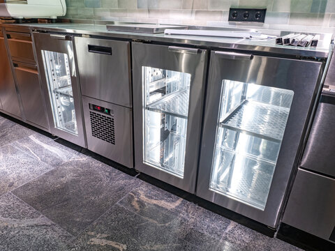 Industrial refrigeration equipment. Cabinets for storing refrigerated products. Industrial refrigerators in restaurant. Equipment for catering establishments. Refrigerators with transparent doors