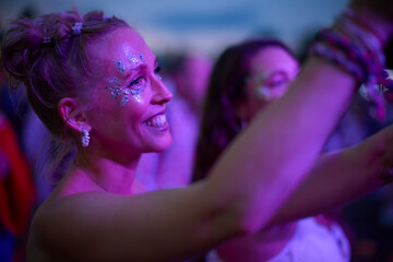 Woman Watching Band Dancing At Outdoor Summer Music Festival Holding Drinks At Night