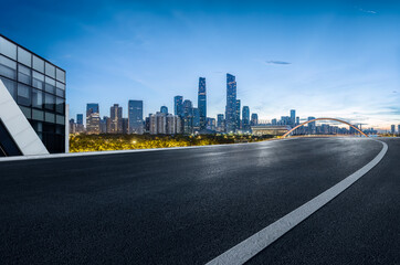 Empty asphalt road and city buildings landscape at night in Guangzhou