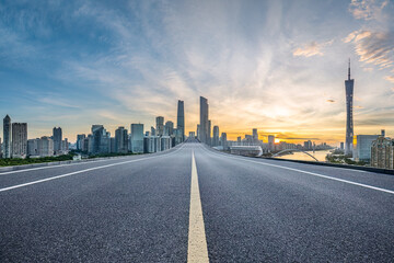 Empty asphalt road and city buildings landscape at night in Guangzhou