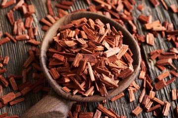 Red sandalwood chips on a wooden spoon