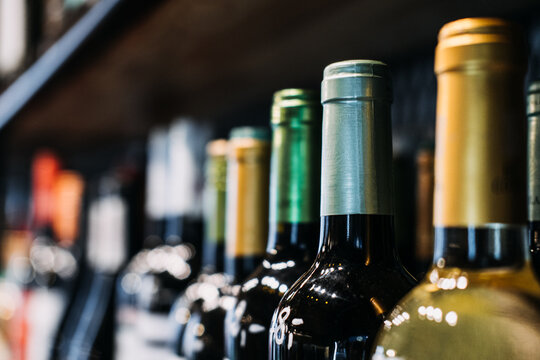 How choose wine. Assorted Wine Bottles on Display in a Store. A selective focus labels of a variety of wine bottles on a shelf, highlighting the diversity in a wine store.