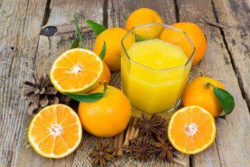 orange juice and some fresh fruits on wooden background