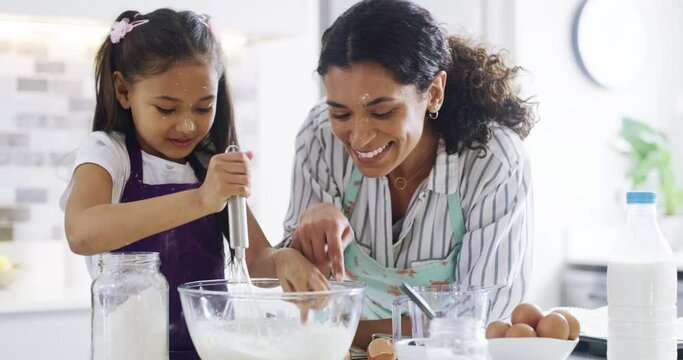 Mother, daughter and happy with baking in kitchen with fun for learning, child development and bonding with play at home. Family, woman and kid with apron for cooking, support and dessert with love
