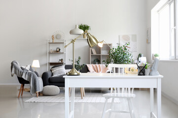 Interior of living room with workplace and glowing lamps
