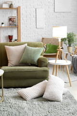 Interior of living room with glowing lamp and green sofa