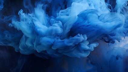 Blue ink in water on a black background. Abstract background for design.