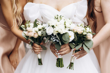 Bride holding her wedding bouquet with bridesmaids