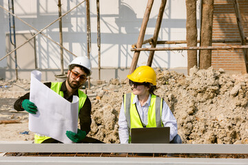 Engineers and Architect Caucasian looking at blueprint of building construction, planning the work in a professional. inspector is looking at steel structure and materials at construction site.