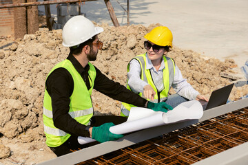 Engineers and Architect Caucasian looking at blueprint of building construction, planning the work in a professional. inspector is looking at steel structure and materials at construction site.