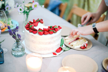 Crop woman cutting cake during banquet