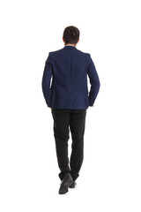 Young businessman walking away on white background, back view