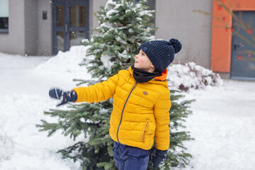 Fototapeta na wymiar Winter games outdoors. Snowball fight. Kid having fun and playing snowballs.