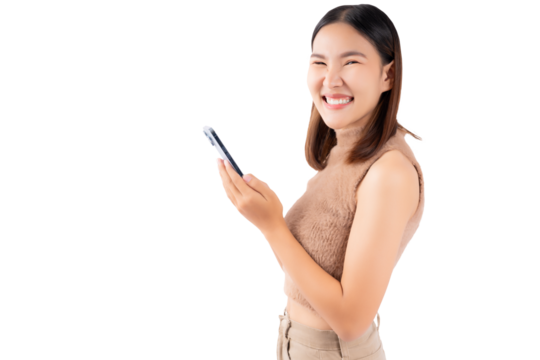 Happy excited young asian girl using mobile phone isolated on white background copy space Young girl using smartphone for shopping online chat and texting message She get surprised looking at camera