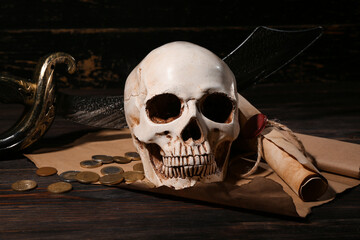 Human skull with sword, scroll and coins on brown wooden background