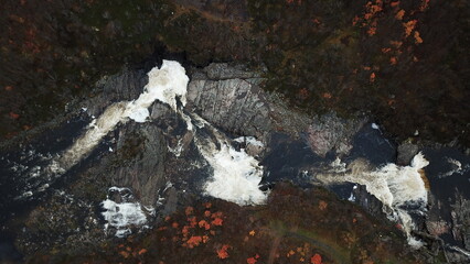 a mountain waterfall from a bird's eye view in autumn