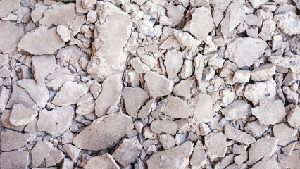 Concrete that is broken into pieces due to the hammering for construction.Background broken of concrete on the floor.