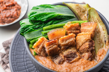 Crispy Pork Kare Kare (Peanut Sauce) with Vegetables and Shrimp Paste on the side 

