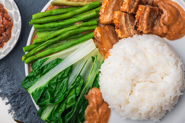 Crispy Pork Kare Kare (Peanut Sauce) with Vegetables and Shrimp Paste on the side 

