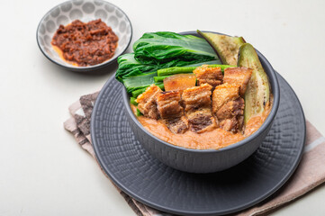 Crispy Pork Kare Kare (Peanut Sauce) with Vegetables and Shrimp Paste on the side 

